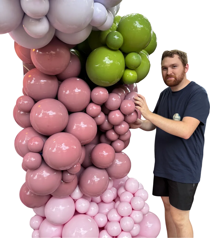 Thibault Agius, fondateur de Secrets Obscurs, devant une colonne de ballons